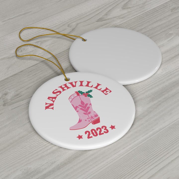 Vibrant pink Nashville 2023 Cowgirl Boot Ornament featuring festive holly leaves, perfect for Nashville and country music lovers